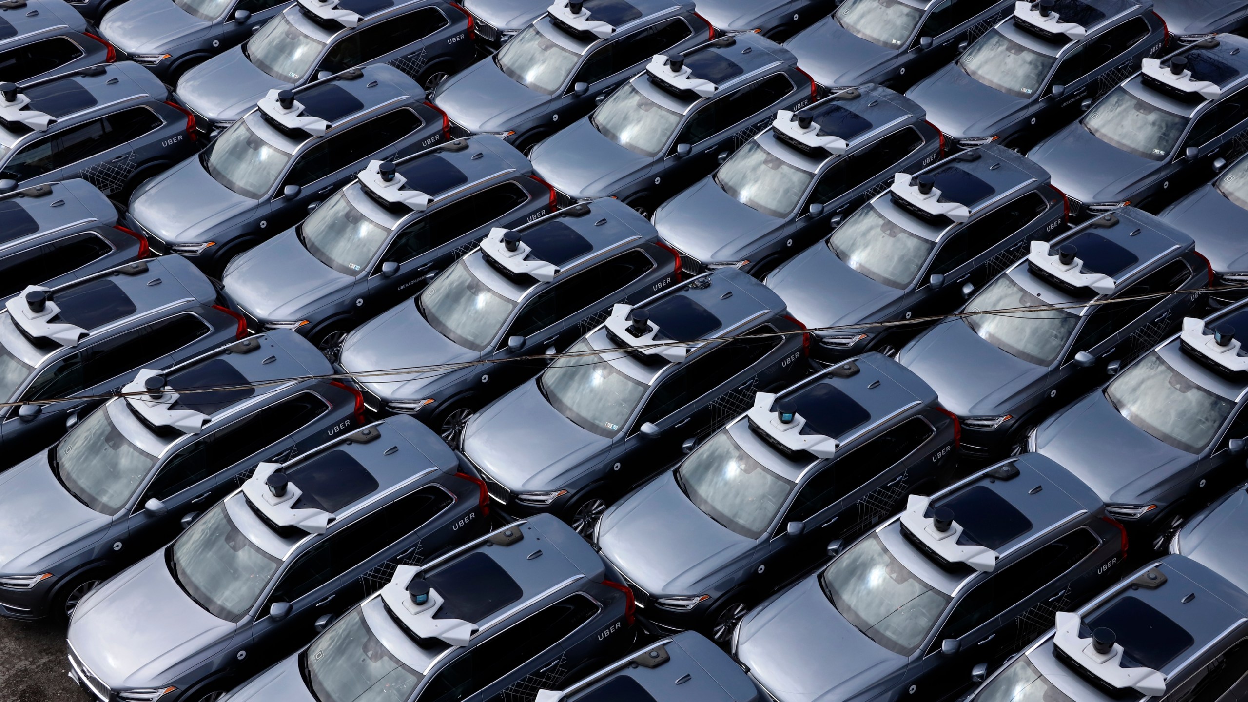 A parking lot full of Uber self-driving Volvos is seen in Pittsburgh on March 20, 2020. (Gene J. Puskar / Associated Press)