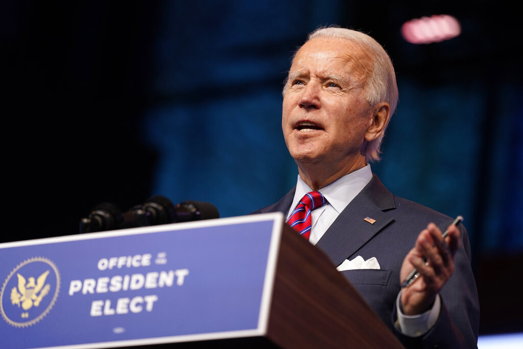 In this Dec. 4, 2020, photo, President-elect Joe Biden speaks about jobs at The Queen theater in Wilmington, Del. (AP Photo/Andrew Harnik)