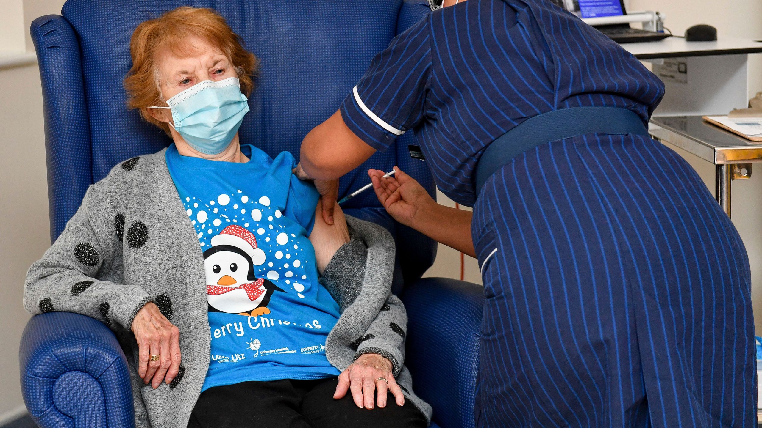 Pictured is 90-year-old Margaret Keenan, the first patient in the UK to receive the Pfizer-BioNTech COVID-19 vaccine, administered by nurse May Parsons at University Hospital, Coventry, England, on Dec. 8, 2020. (Jacob King/Pool via AP)