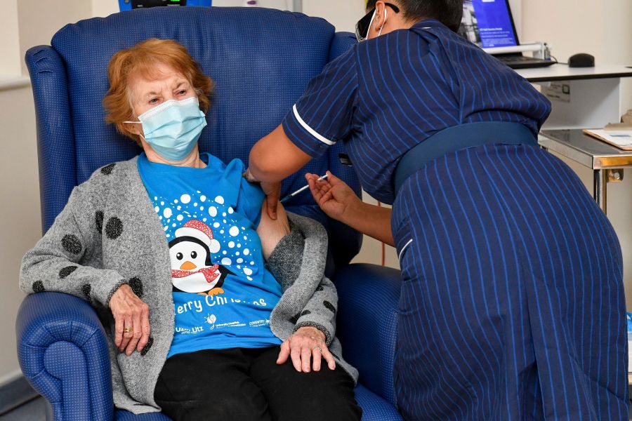 Pictured is 90-year-old Margaret Keenan, the first patient in the UK to receive the Pfizer-BioNTech COVID-19 vaccine, administered by nurse May Parsons at University Hospital, Coventry, England, on Dec. 8, 2020. (Jacob King/Pool via AP)