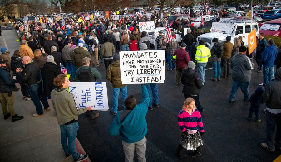 In this Dec. 8, 2020, file photo, anti-masker demonstrators converge on Central District Health offices in Boise, Idaho, to the protest a meeting deciding on more mandates to combat the spread of COVID-19. (Darin Oswald/Idaho Statesman via AP, File)