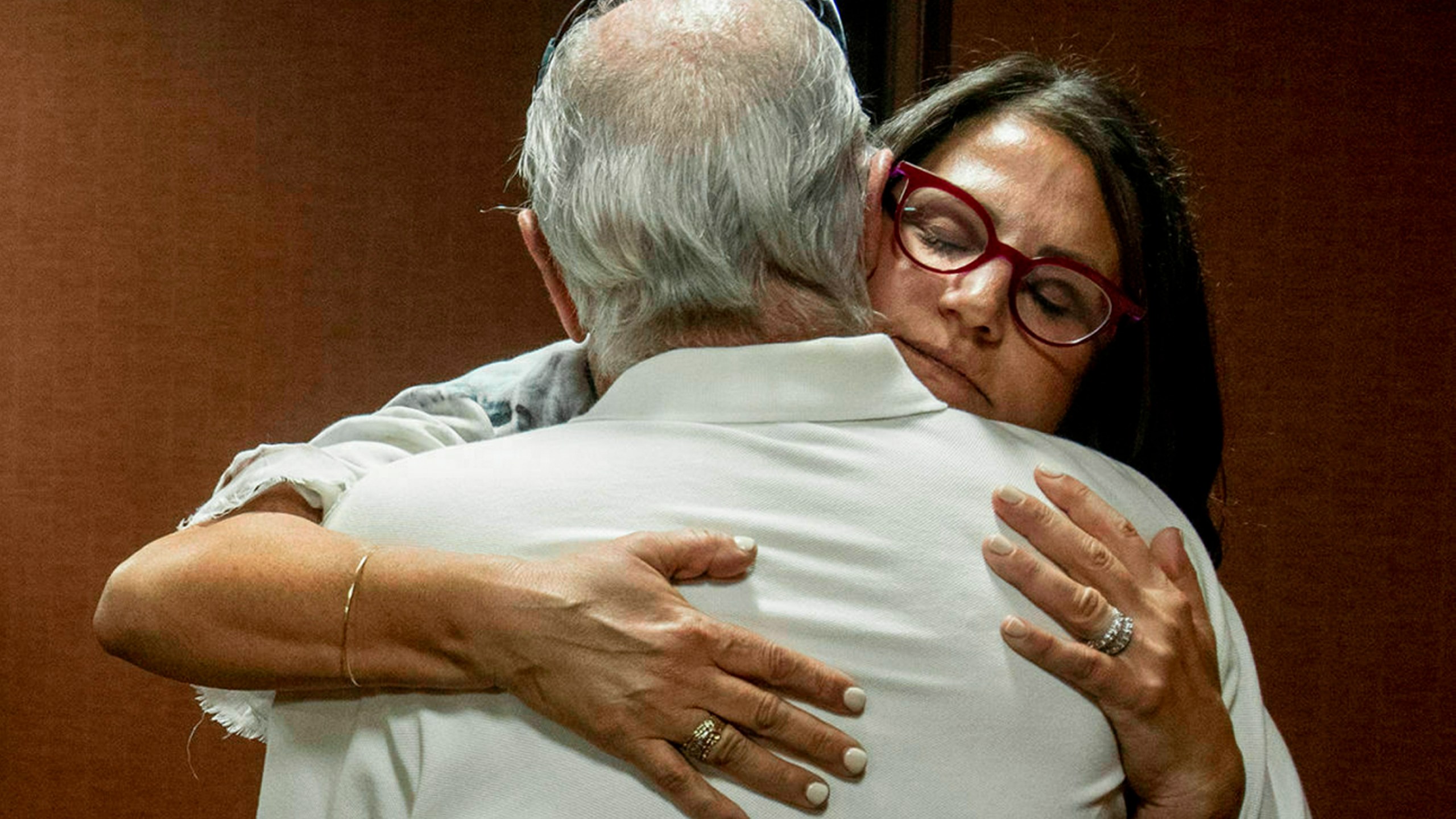 In this July 11, 2019 file photo, Tanya Gersh, a Montana real estate agent, embraces her father Lloyd Rosenstein following a hearing at the Russell Smith Federal Courthouse in Missoula. Mont. (Ben Allen/The Missoulian via AP, File)