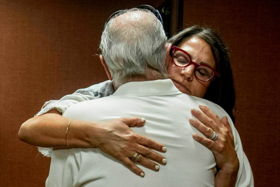 In this July 11, 2019 file photo, Tanya Gersh, a Montana real estate agent, embraces her father Lloyd Rosenstein following a hearing at the Russell Smith Federal Courthouse in Missoula. Mont. (Ben Allen/The Missoulian via AP, File)