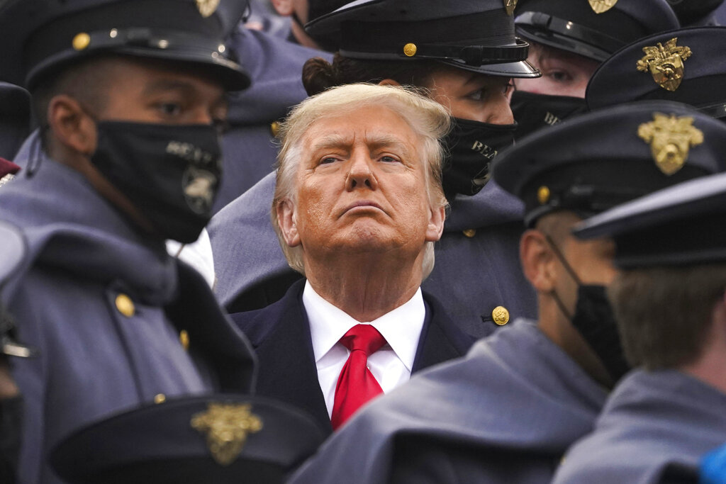 Surrounded by Army cadets, President Donald Trump watches the first half of the 121st Army-Navy Football Game in Michie Stadium at the United States Military Academy, on Dec. 12, 2020, in West Point, N.Y. (AP Photo/Andrew Harnik)