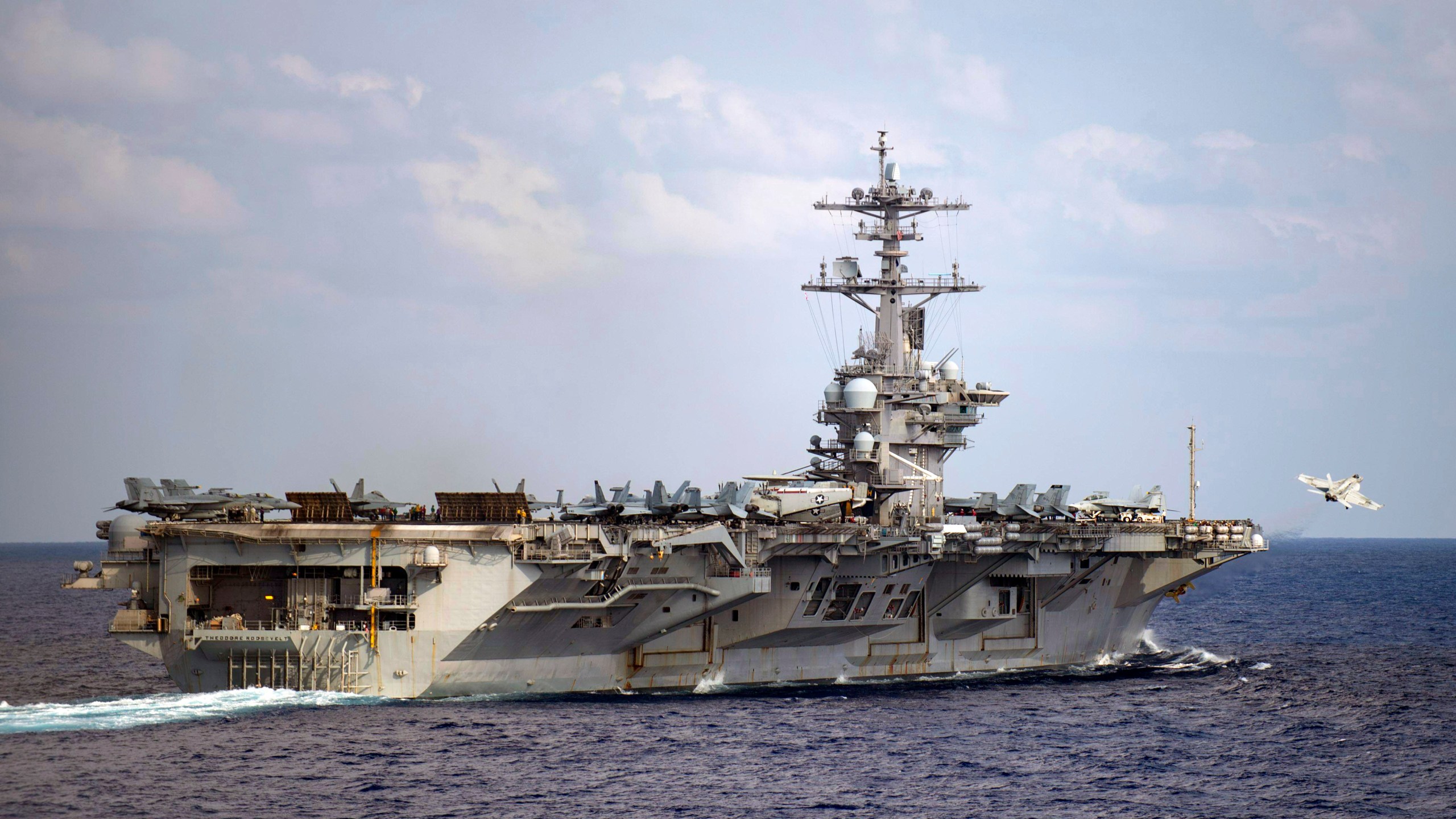 In this March 18, 2020 file photo provided by the U.S. Navy, an F/A-18F Super Hornet launches from the flight deck of the aircraft carrier USS Theodore Roosevelt (CVN 71) in the western North Pacific Ocean. (Mass Communication Specialist 3rd Class Nicholas V. Huynh/U.S. Navy via AP)