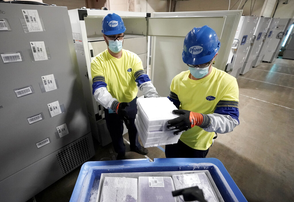 Boxes containing the Pfizer-BioNTech COVID-19 vaccine are prepared to be shipped at the Pfizer Global Supply Kalamazoo manufacturing plant in Portage, Mich. on Dec. 13, 2020. (AP Photo/Morry Gash, Pool)