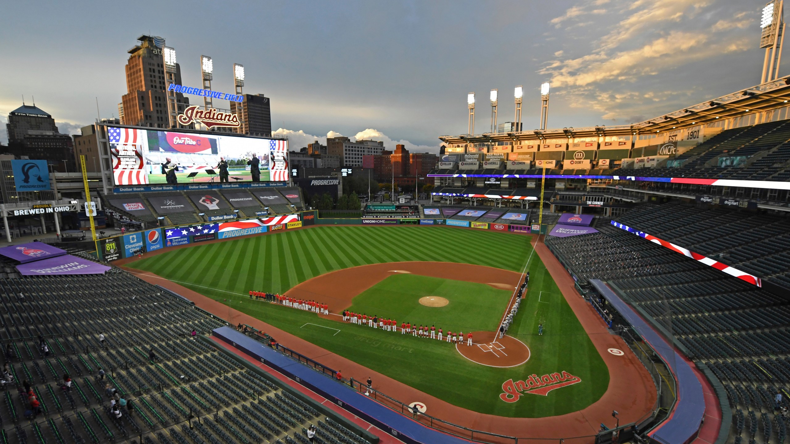 In this Sept. 29, 2020, file photo, players and coaches for the New York Yankees and the Cleveland Indians stand for the national anthem before Game 1 of an American League wild-card baseball series in Cleveland. (David Dermer/AP Photo)