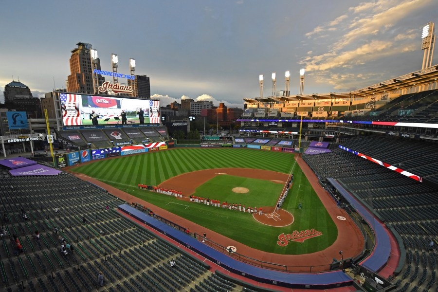 In this Sept. 29, 2020, file photo, players and coaches for the New York Yankees and the Cleveland Indians stand for the national anthem before Game 1 of an American League wild-card baseball series in Cleveland. (David Dermer/AP Photo)