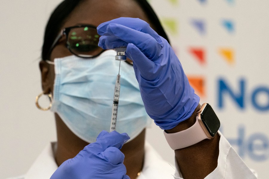 Dr. Michelle Chester draws the Pfizer-BioNTech COVID-19 vaccine into a syringe at Long Island Jewish Medical Center in the Queens borough of New York on Dec. 14, 2020. (Mark Lennihan / Associated Press)