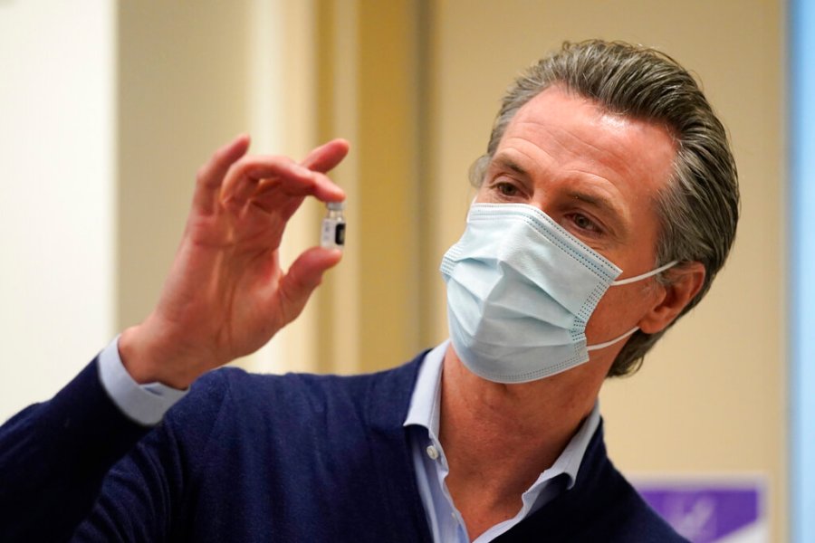 California Gov. Gavin Newsom holds up a vial of the Pfizer-BioNTech COVID-19 vaccine at Kaiser Permanente Los Angeles Medical Center on Dec. 14, 2020. (AP Photo/Jae C. Hong)