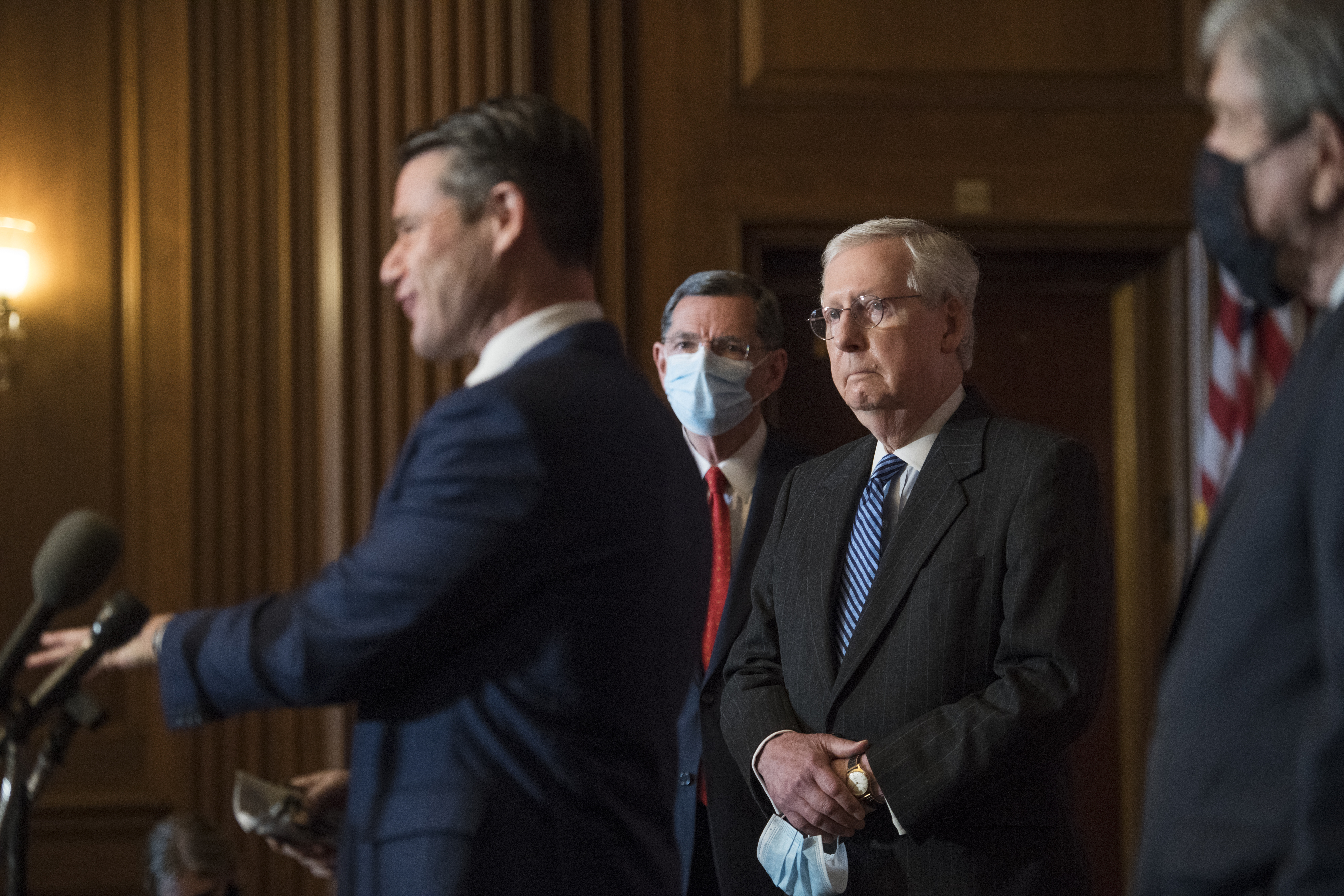 Senate Majority Leader Mitch McConnell of Ky., listens as Sen. Todd Young, R-Ind., speaks during a news conference with other Senate Republicans on Capitol Hill in Washington, Tuesday, Dec. 15, 2020. (Rod Lamkey/Pool via AP)