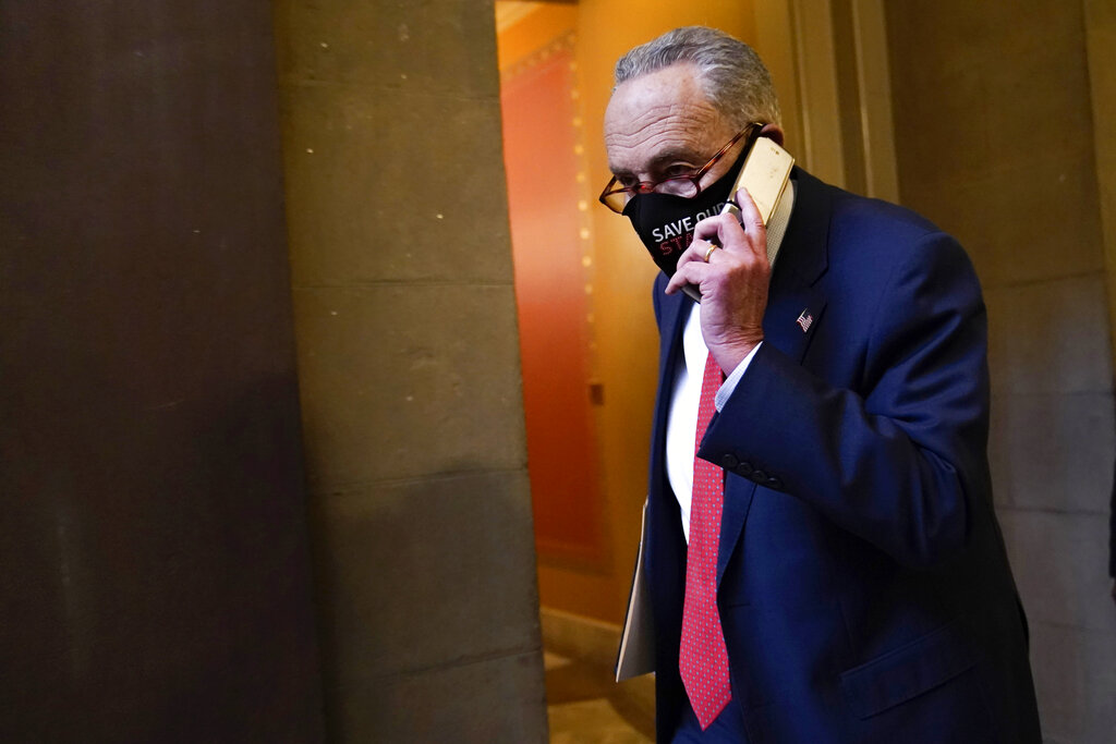 Senate Minority Leader Sen. Chuck Schumer of N.Y., walks on Capitol Hill in Washington, Tuesday, Dec. 15, 2020. (AP Photo/Susan Walsh)