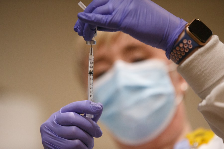 Tami Jeffries, RN, prepares the first locally available dose of the Pfizer-BioNTech COVID-19 vaccine at Mary Washington Hospital in Fredericksburg, Va., on Dec. 15, 2020. (Mike Morones/The Free Lance-Star via Associated Press)