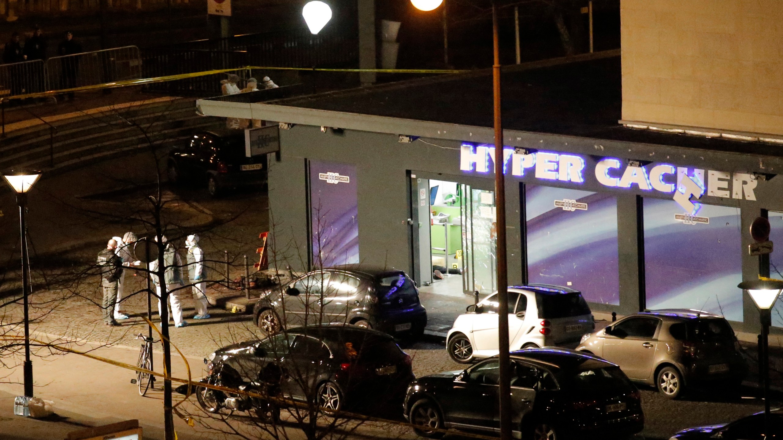 In this Friday Jan. 9, 2015 file photo, police officers work at the scene of a Kosher market in Paris after attacker Amedy Coulibaly took hostages. (Francois Mori/Associated Press)