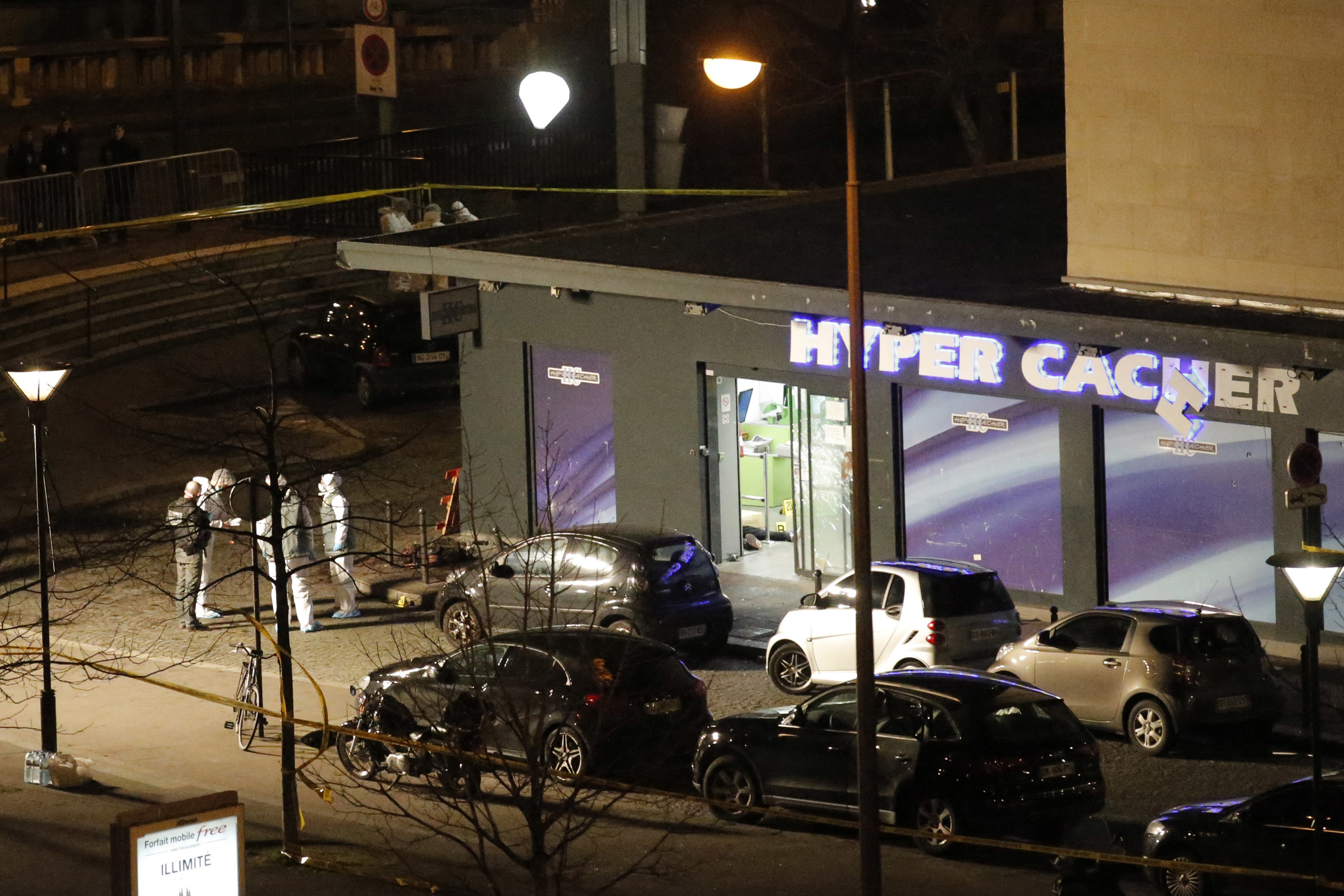 In this Friday Jan. 9, 2015 file photo, police officers work at the scene of a Kosher market in Paris after attacker Amedy Coulibaly took hostages. (Francois Mori/Associated Press)