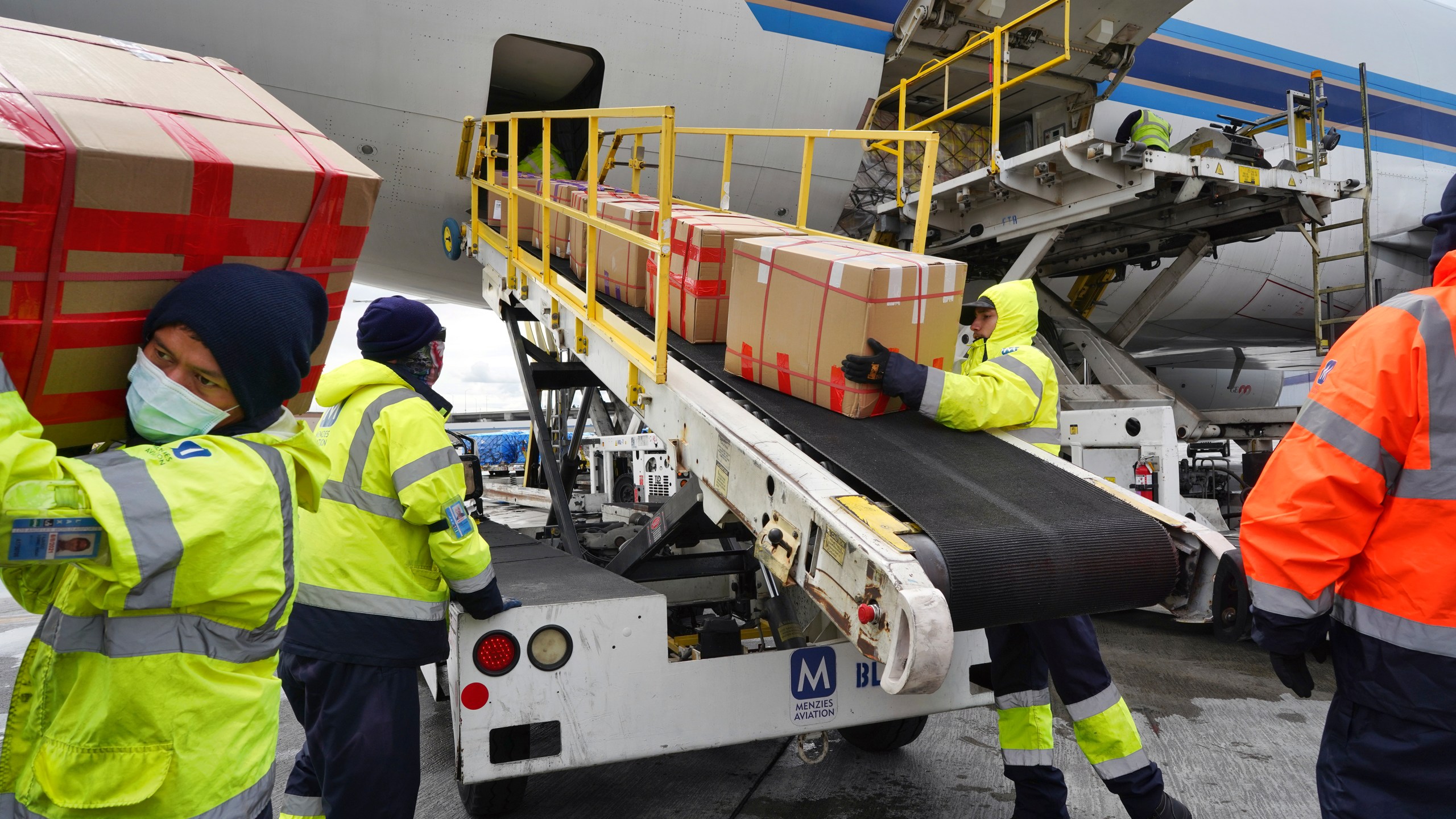 Wearing protective masks, ground crew at the Los Angeles International airport unload supplies of medical personal protective equipment from a China Southern cargo plane upon it's arrival on Friday, April 10, 2020. (Richard Vogel/AP Photo)