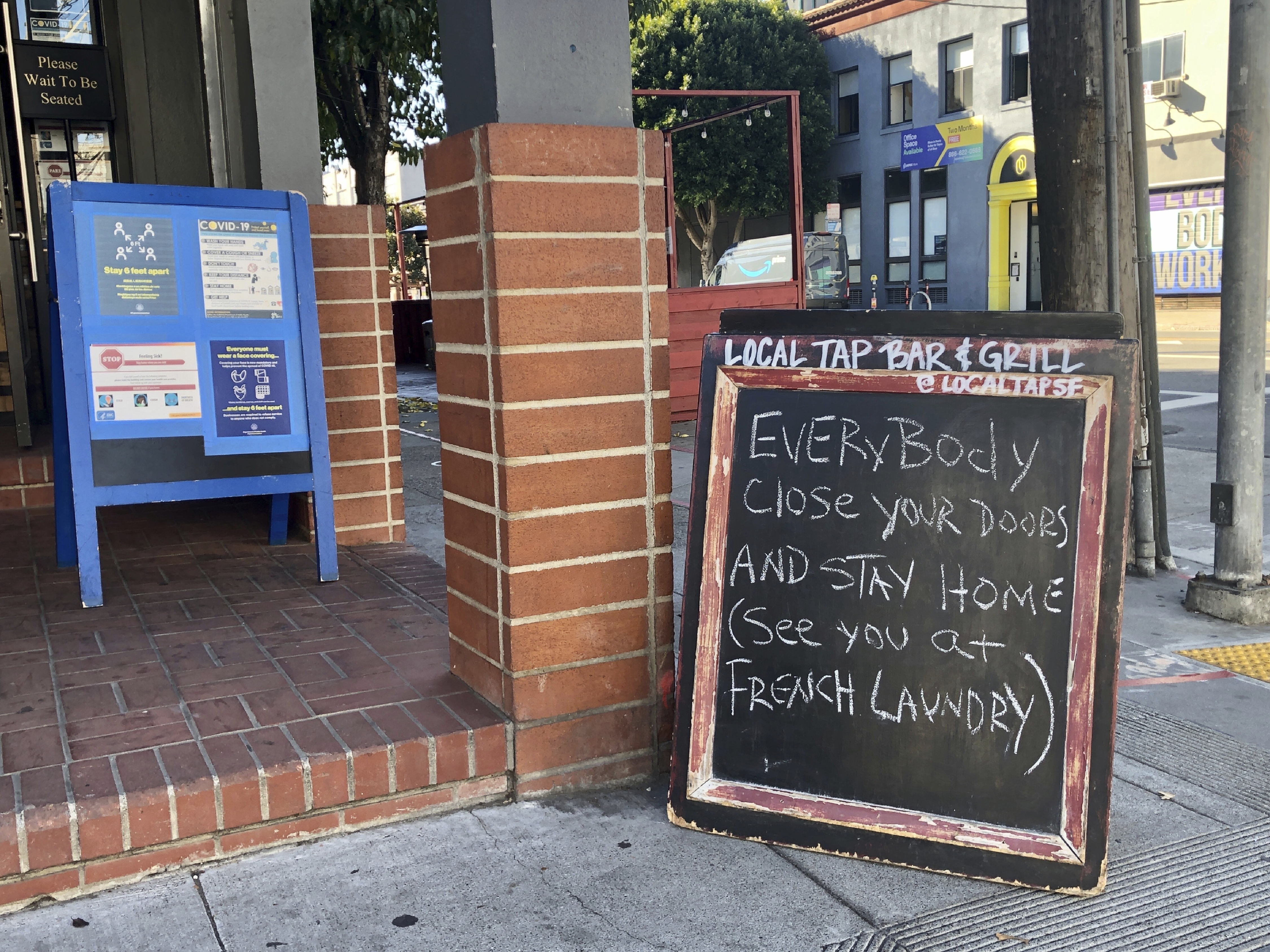 A sign calling out California Gov. Gavin Newsom for not following his own pandemic protocols at the French Laundry restaurant is seen in San Francisco on Dec. 8, 2020. (Juliet Williams/AP Photo)