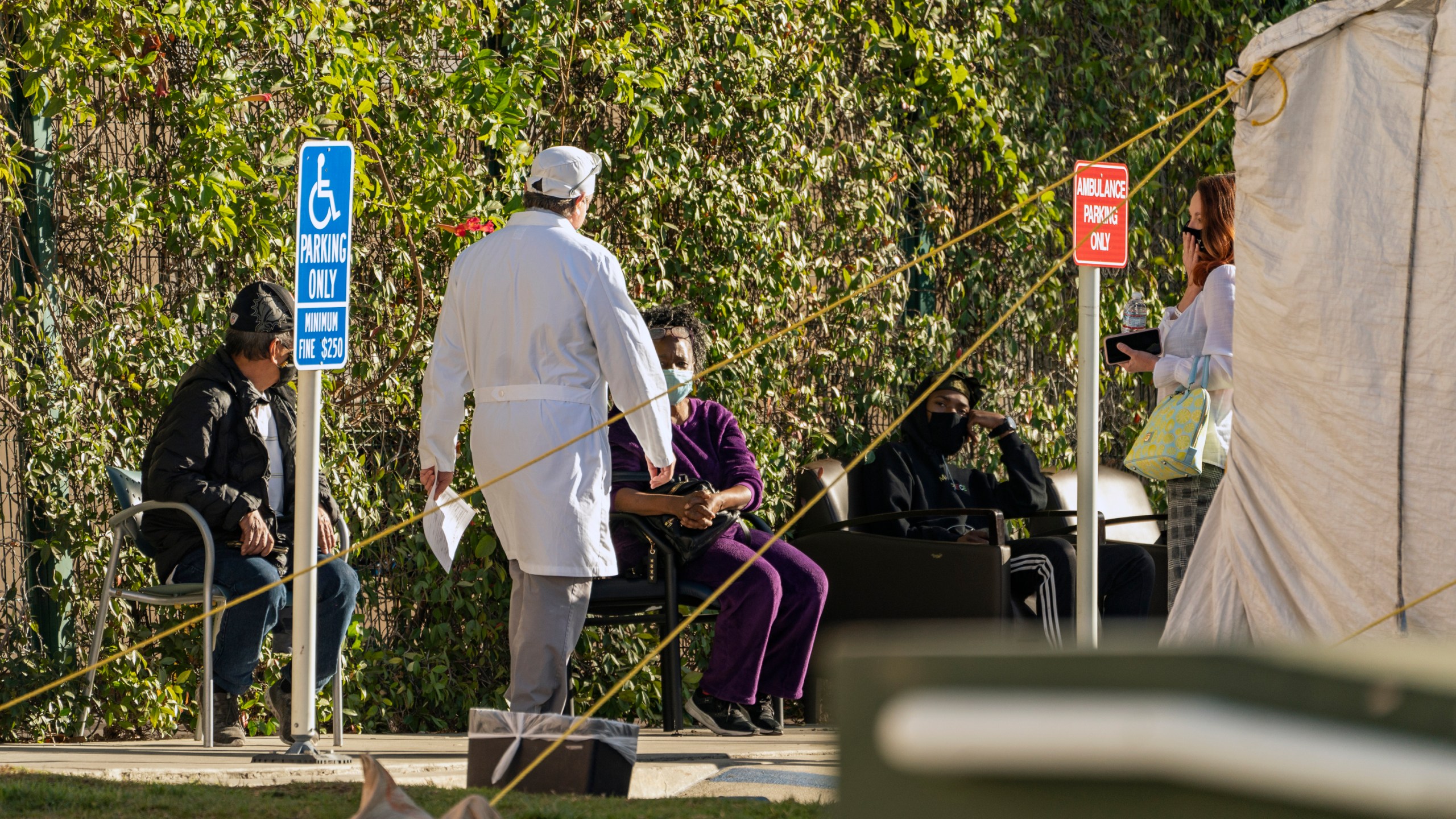 Patients wait in line for medical evaluation next to medical tents set at the CHA Hollywood Presbyterian Medical Center in Los Angeles Friday, Dec. 18, 2020. (Damian Dovarganes/AP Photo)