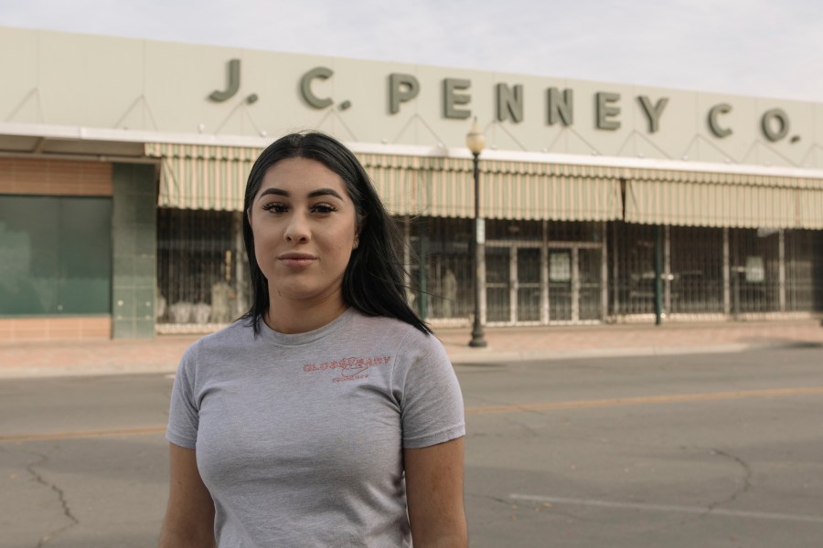 Alexandra Orozco stands for a portrait outside of the closed J.C. Penney where she was laid off from, in Delano, Calif., on Sunday, Dec. 6, 2020. (Madeline Tolle/The Fuller Project via AP)