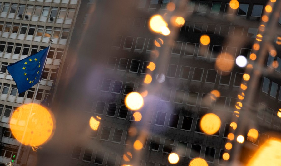 European Union flags flutter in the wind amongst Christmas decorations outside of EU headquarters in Brussels, on Dec. 23, 2020. (AP Photo/Virginia Mayo)