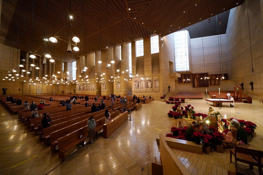 Worshipers gather for Christmas Eve Mass inside the Cathedral of Our Lady of the Angels Thursday, Dec 24, 2020, in Los Angeles. (AP Photo/Ashley Landis)