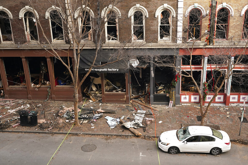 In this Dec. 29, 2020 file photo, debris remains on the sidewalk in front of buildings damaged in a Christmas Day explosion in Nashville, Tenn. (AP Photo/Mark Humphrey, File)