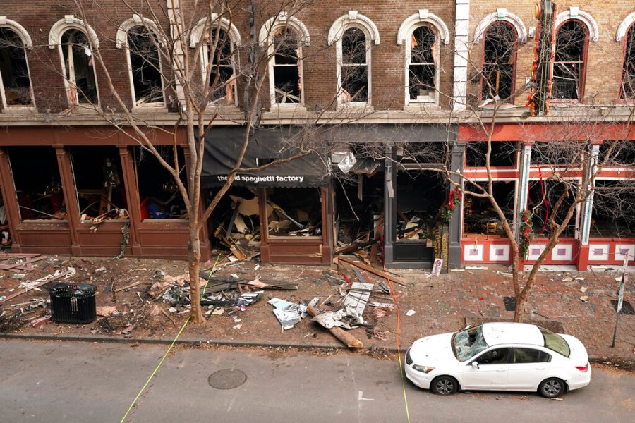 In this Dec. 29, 2020 file photo, debris remains on the sidewalk in front of buildings damaged in a Christmas Day explosion in Nashville, Tenn. (AP Photo/Mark Humphrey, File)