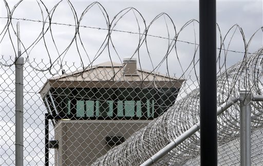 This June 25, 2013 file photo shows a guard tower over the fence surrounding the new California Correctional Health Care Facility in Stockton. (AP Photo/Rich Pedroncelli,File)