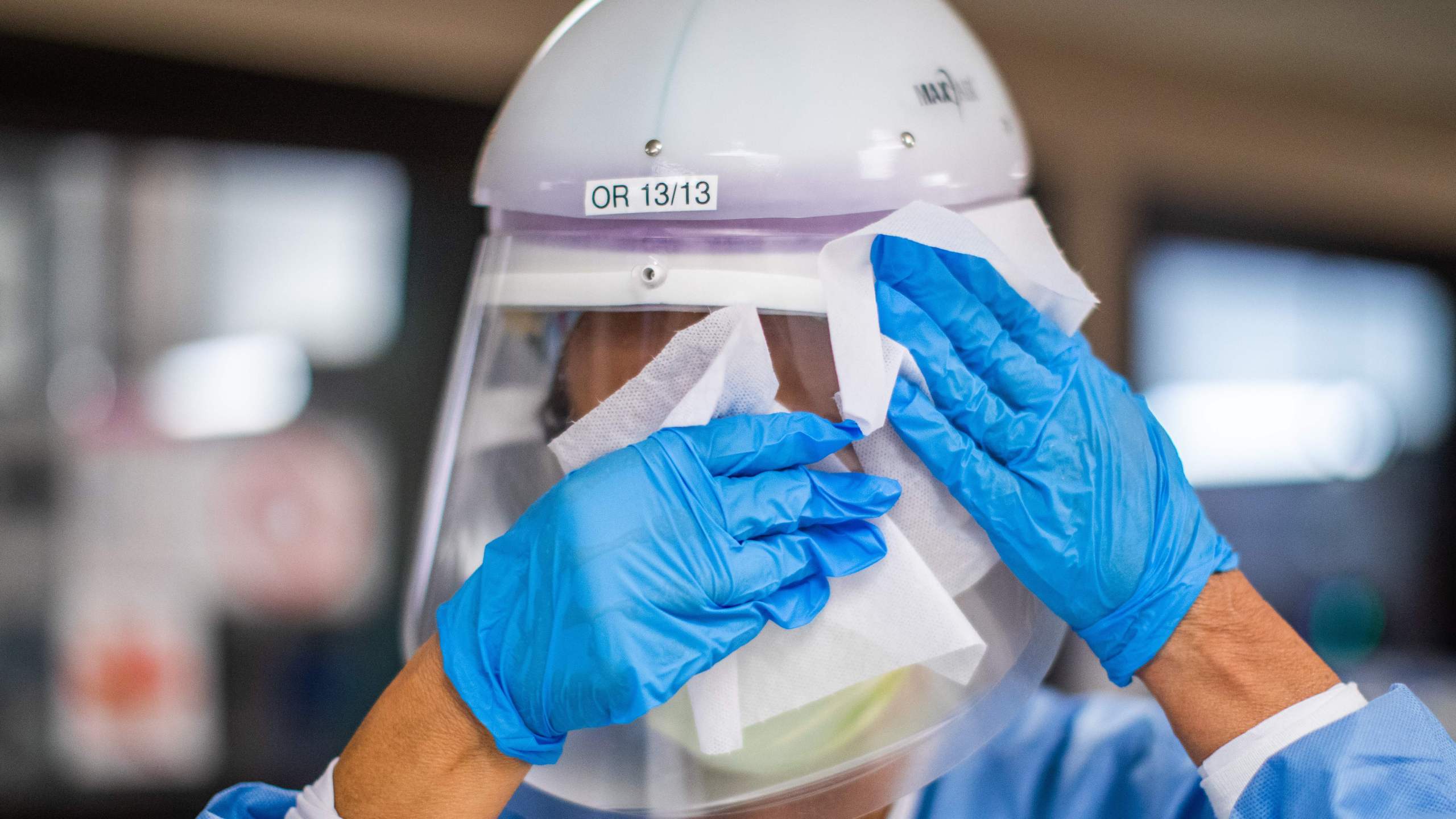 Registered nurse Carmen Verano wipes her CAPR helmet after attending a Covid-19 patient in the Intensive Care Unit (ICU) at Providence Cedars-Sinai Tarzana Medical Center in Tarzana, California on December 18, 2020. (APU GOMES/AFP via Getty Images)