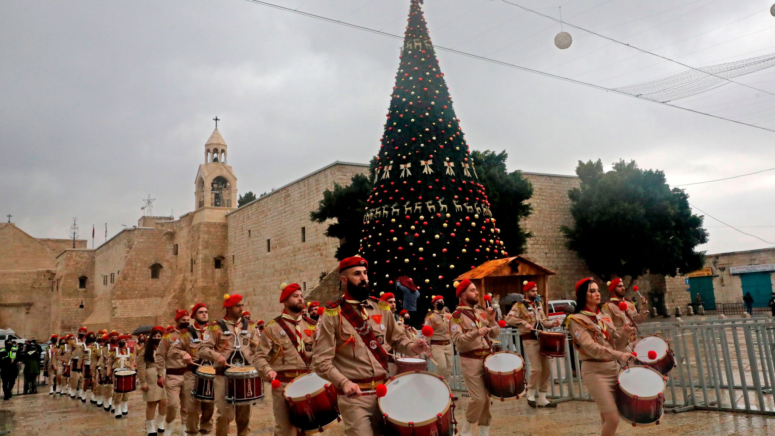 A Palestinian scouts band parades in front of the Church of the Nativity during Christmas celebrations in the biblical city of Bethlehem in the occupied West Bank, on December 24, 2020. (HAZEM BADER/AFP via Getty Images)