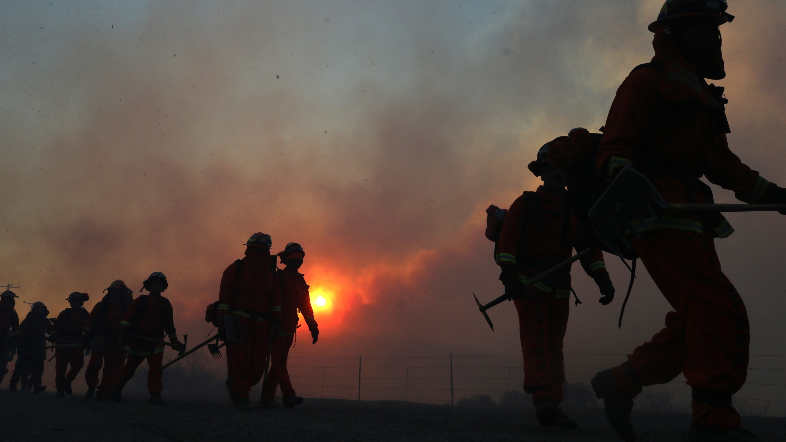 Inmate firefighters work as the Bond Fire burns shortly after sunrise in the Silverado Canyon area of Orange County on Dec. 3, 2020 near Irvine, California. (Mario Tama/Getty Images)