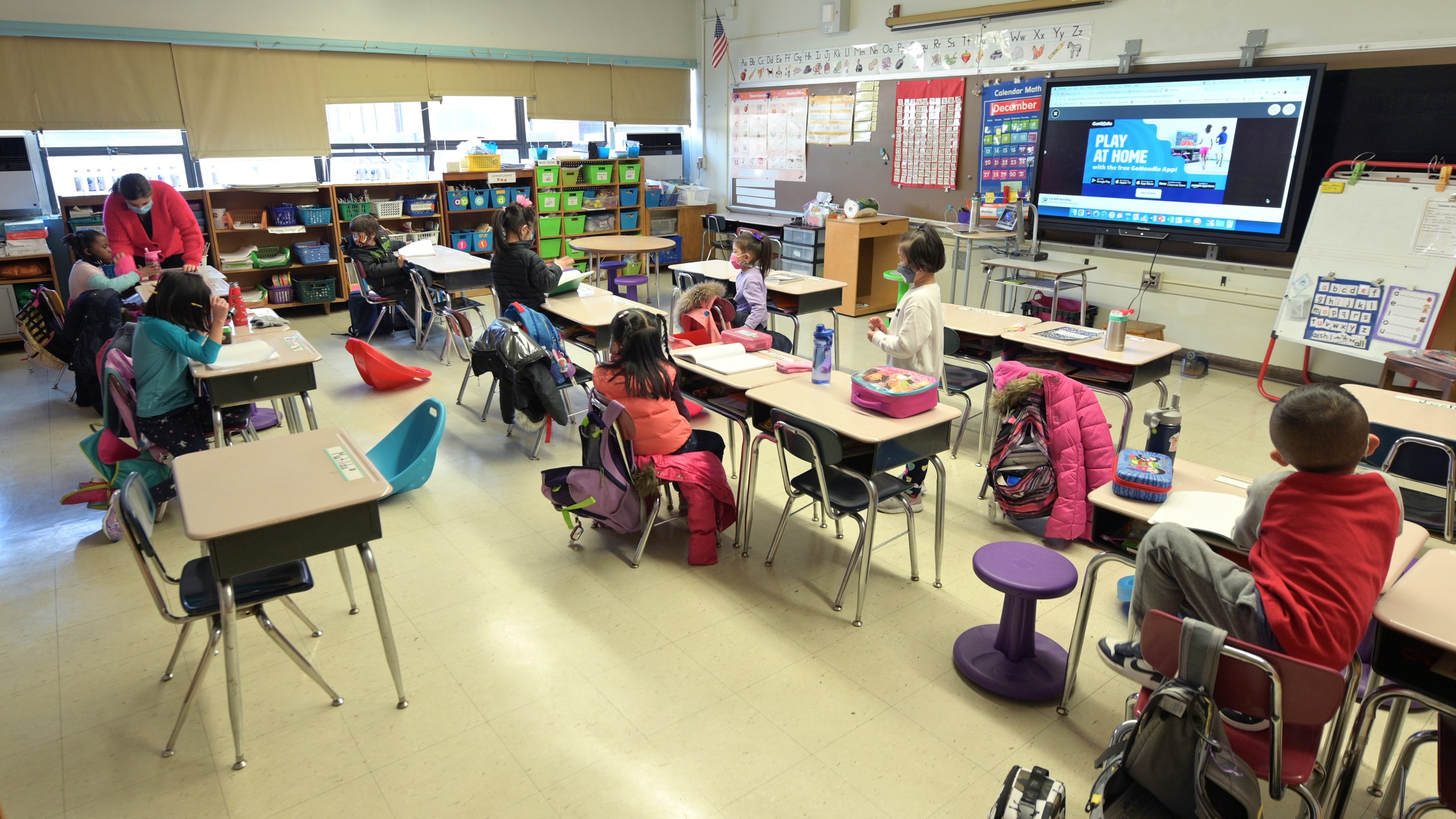 Jackie Sato (L), a teacher at Yung Wing School P.S. 124 teaches blended learning students during the first day back to school on Dec. 7, 2020 at Yung Wing School P.S. 124 in New York City. Students whose parents opted for blended learning returned to school today after all were shut down on Nov. 18, when New York City had reached a citywide positivity rate of three percent of all coronavirus tests performed over a seven-day period. (Photo by Michael Loccisano/Getty Images)