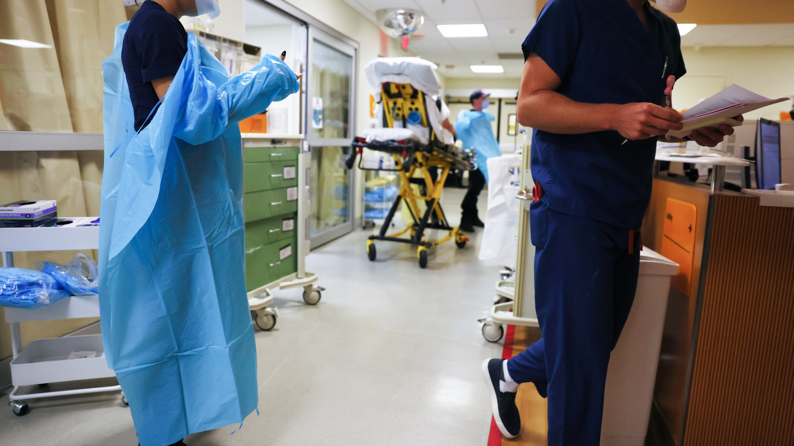 A clinician dons PPE (personal protective equipment) as she prepares to enter a patient's room in the emergency room at Sharp Memorial Hospital on December 15, 2020 in San Diego, California. (Mario Tama/Getty Images)