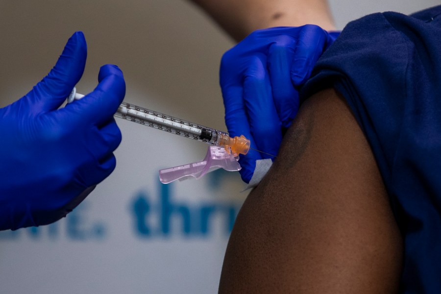 A nurse administers the Pfizer-BioNTech COVID-to another nurse during a vaccine event at Kaiser Permanente Capitol Hill Dec.17, 2020 in Washington, DC. (Shawn Thew-Pool/Getty Images)