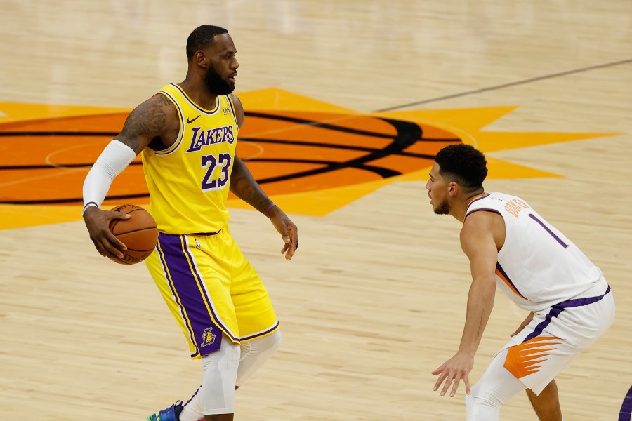 LeBron James #23 of the Los Angeles Lakers handles the ball against Devin Booker #1 of the Phoenix Suns during the NBA preseason game at Talking Stick Resort Arena on Dec. 18, 2020, in Phoenix, Arizona. (Christian Petersen/Getty Images)