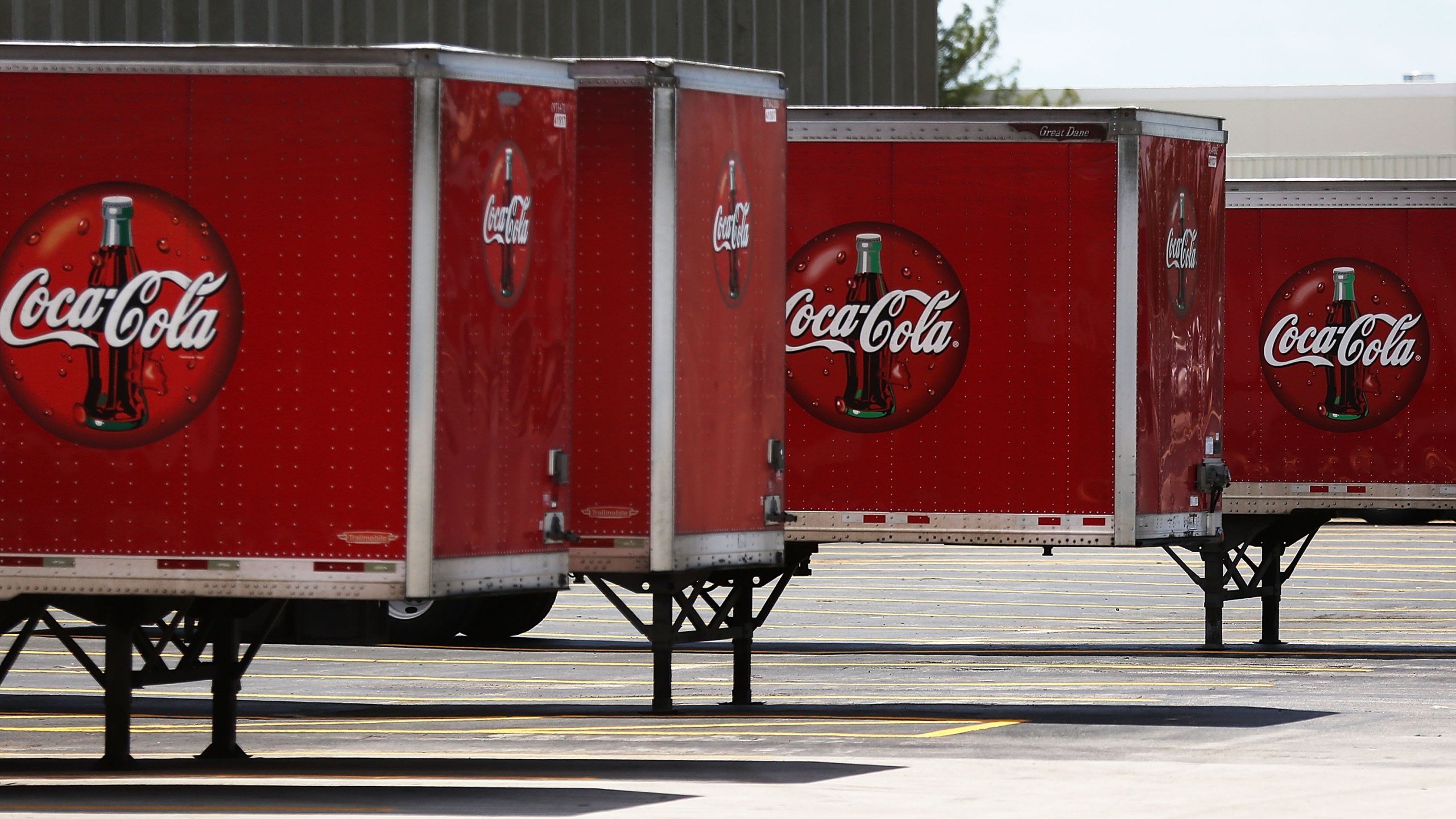 Coca Cola trucks are seen at a distribution center as the company announces plans to cut 1200 corporate staff jobs on April 25, 2017 in Hollywood, Florida. (Photo by Joe Raedle/Getty Images)