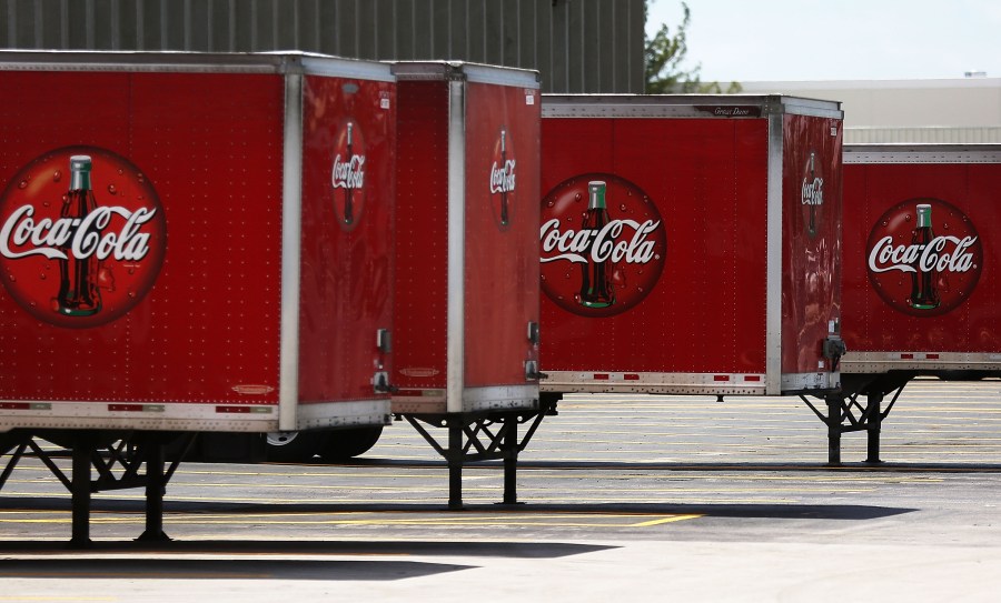 Coca Cola trucks are seen at a distribution center as the company announces plans to cut 1200 corporate staff jobs on April 25, 2017 in Hollywood, Florida. (Photo by Joe Raedle/Getty Images)