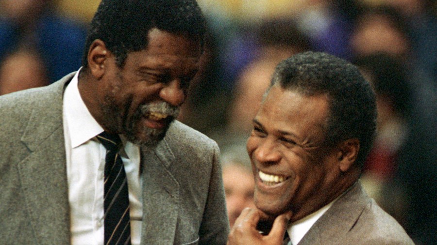 In this Jan. 15, 1988, file photo, former Boston Celtics teammates Bill Russell, Sacramento Kings coach, left, and K.C. Jones, Celtics coach, meet before the start of the Kings-Celtics NBA basketball game at the Boston Garden in Boston. (Mike Kullen/Associated Press)