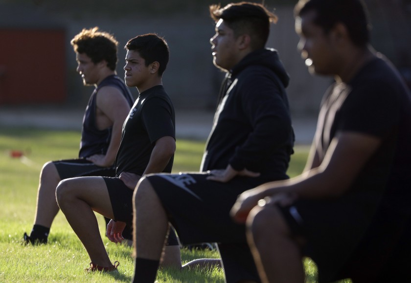 Because of coronavirus surges, school-organized conditioning that began in November 2020 for these football players at Taft High will be on hold till at least January as L.A. campuses begin a hard shutdown for student services.(Myung J. Chun / Los Angeles Times)