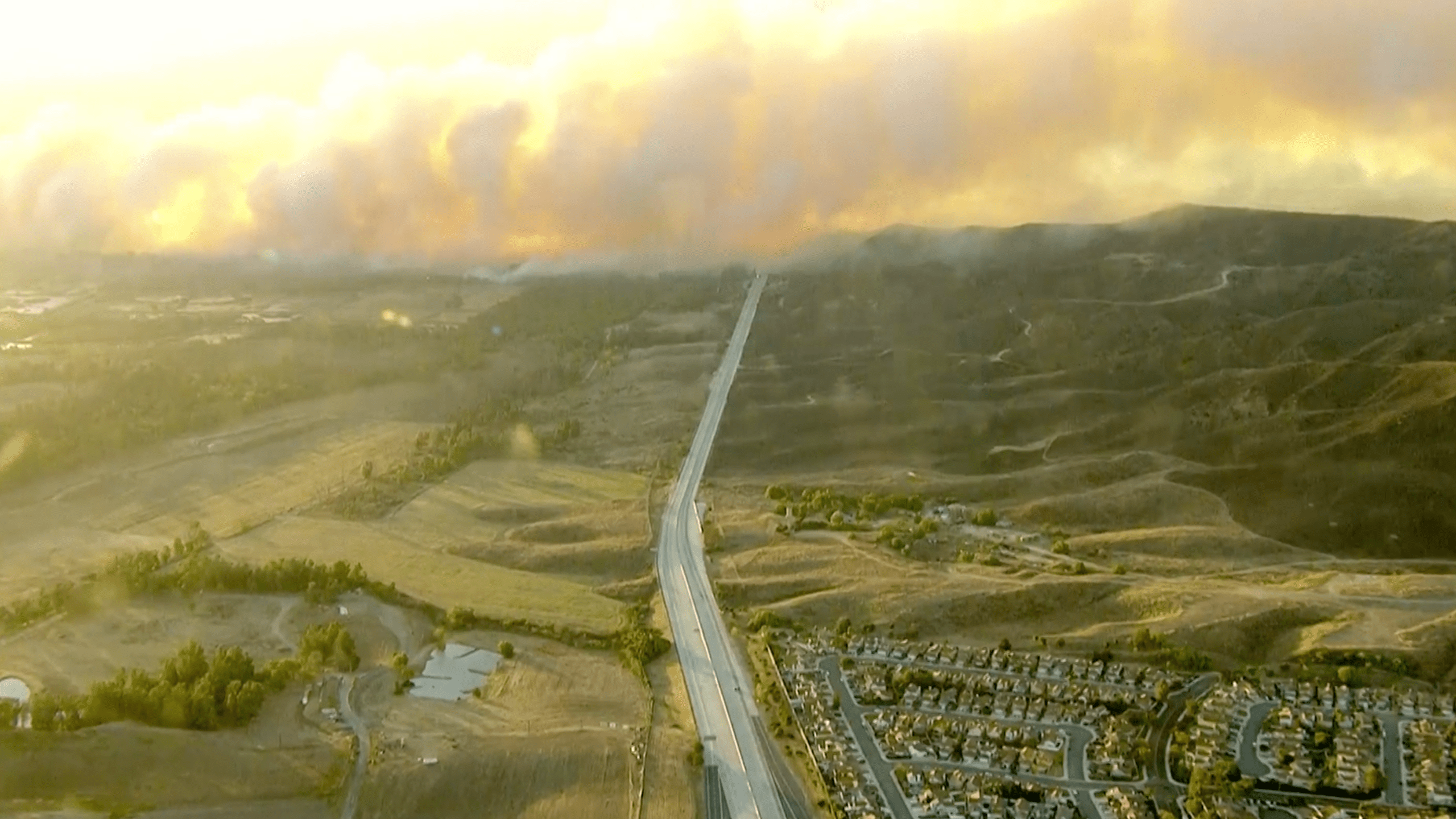 Smoke billows over Corona on Dec. 3, 2020 as firefighters battle the Aviation Fire. (KTLA)