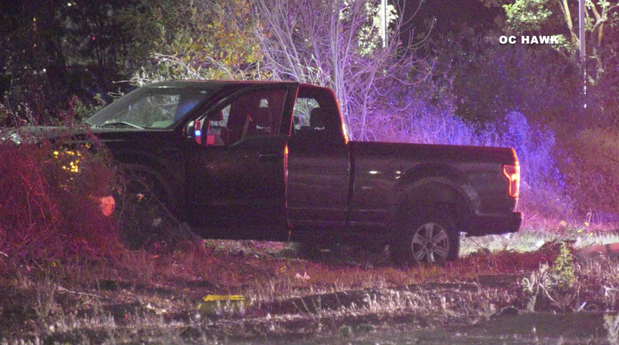 A pickup came to rest on the shoulder of the southbound 15 Freeway in the Ontario area after its driver was fatally shot on Dec. 14, 2020. (OC Hawk)