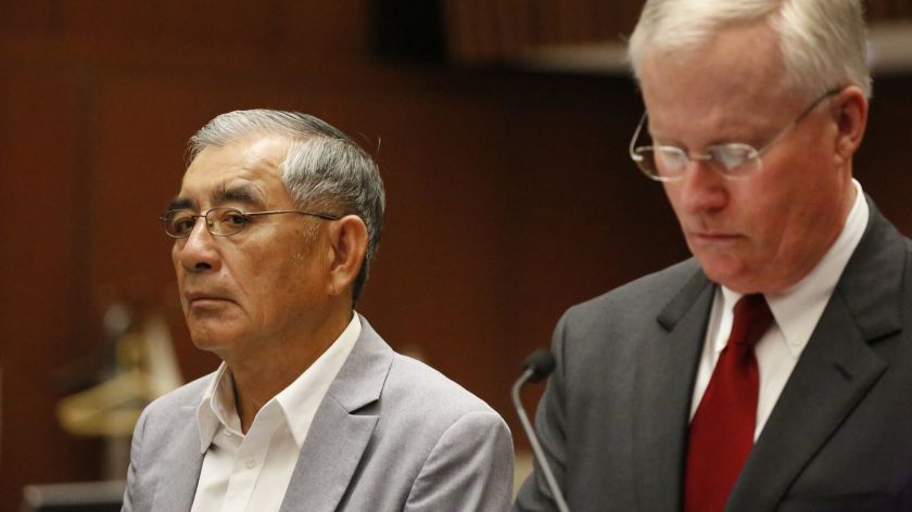 Businessman Samuel Leung, left, stands alongside his lawyer, Daniel V. Nixon, in court in 2018. On Dec. 3, 2020, Leung pleaded guilty to a felony count of conspiracy. (Al Seib / Los Angeles Times)