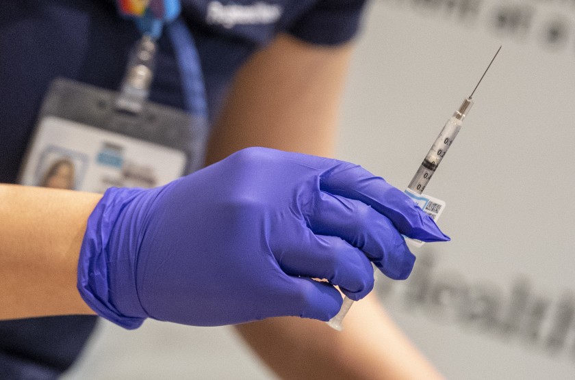 UCLA nurse Eunice Lee prepares a syringe of the Covid-19 vaccine for health care workers at Ronald Reagan UCLA Medical Center in this undated photo. (Brian van der Brug / Los Angeles Times)