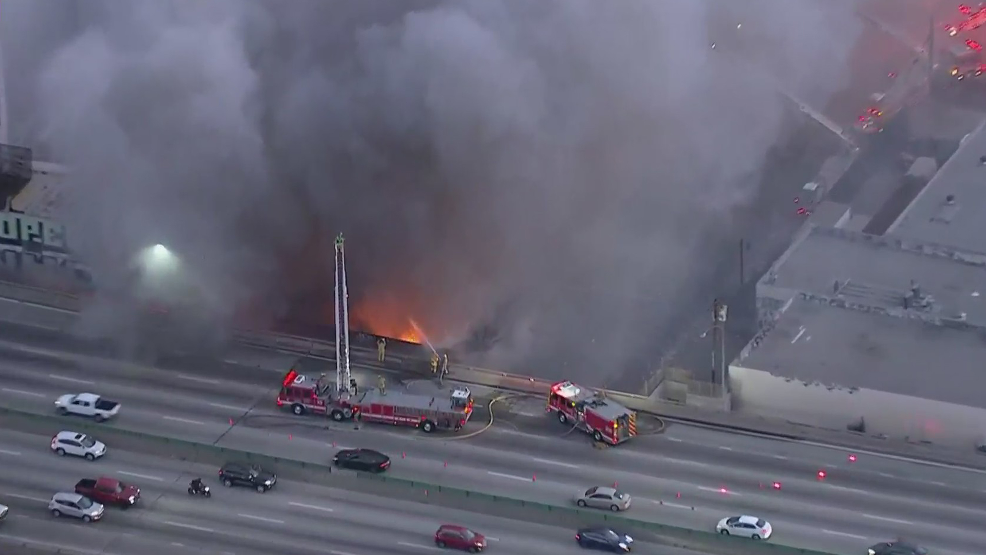 Firefighters battled a blaze at a vacant building in downtown Los Angeles parallel to the 10 Freeway on Dec. 8, 2020. (KTLA)