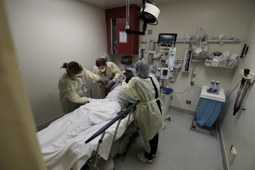 Medical workers treat a COVID-19 patient in May at Riverside University Health System Medical Center in Moreno Valley. (Gina Ferazzi / Los Angeles Times)