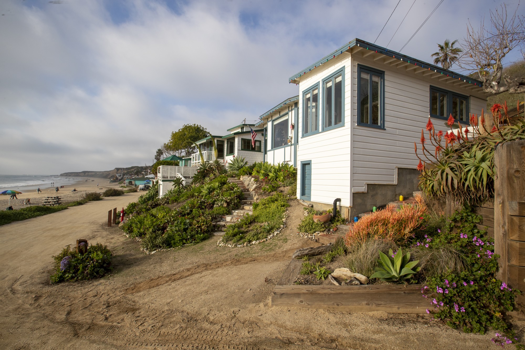 Cottage 21, foreground, and Cottage 17, two doors down, at Crystal Cove State Park are seen in this undated photo. .The cottages are rented to California parks department employees at below-market rates under a program created to allow essential workers to live close to the natural treasures they protect or maintain. (Allen J. Schaben / Los Angeles Times)