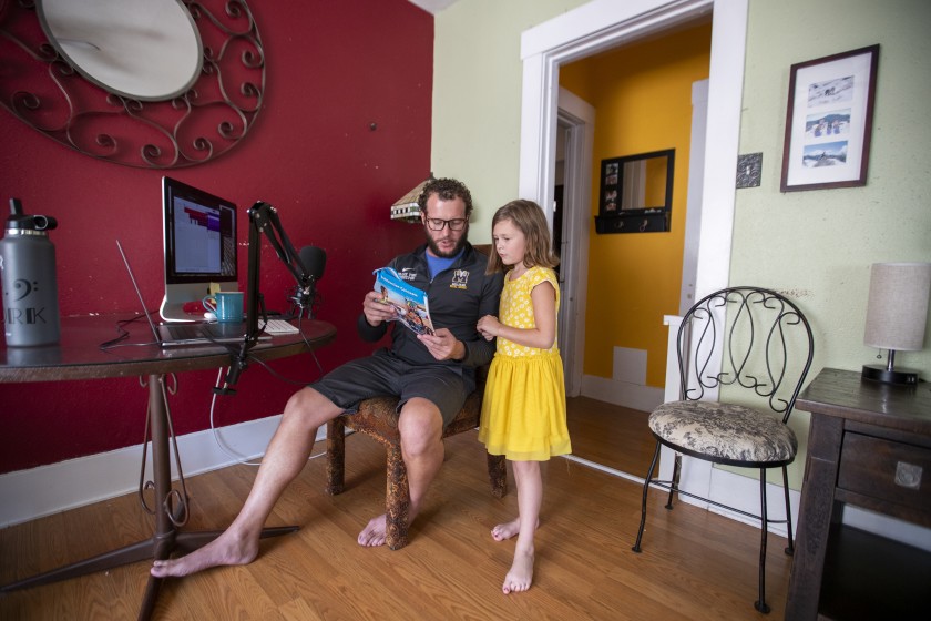 Drake York helps his first-grade daughter, Paisley, with a school question at their Long Beach home in October 2020. (Allen J. Schaben / Los Angeles Times)