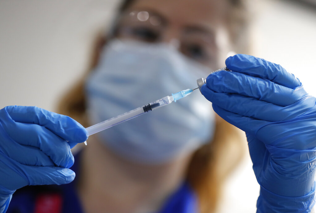 A nurse prepares a shot of the Pfizer-BioNTech COVID-19 vaccine at Guy's Hospital in London, on Dec. 8, 2020, as the U.K. health authorities rolled out a national mass vaccination program. (AP Photo/Frank Augstein, Pool)