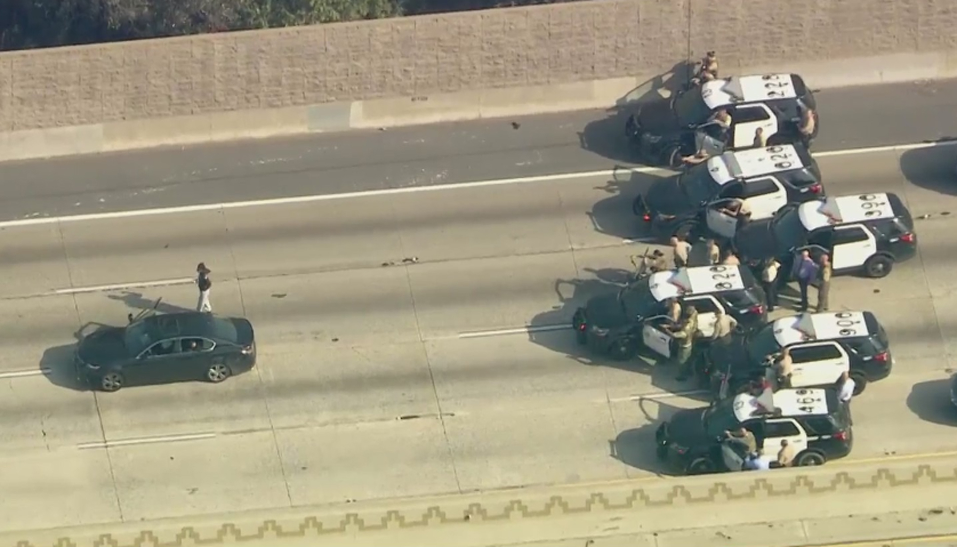 A person surrenders following a pursuit along the 5 Freeway in the Downey area on Jan. 5, 2021. (KTLA)