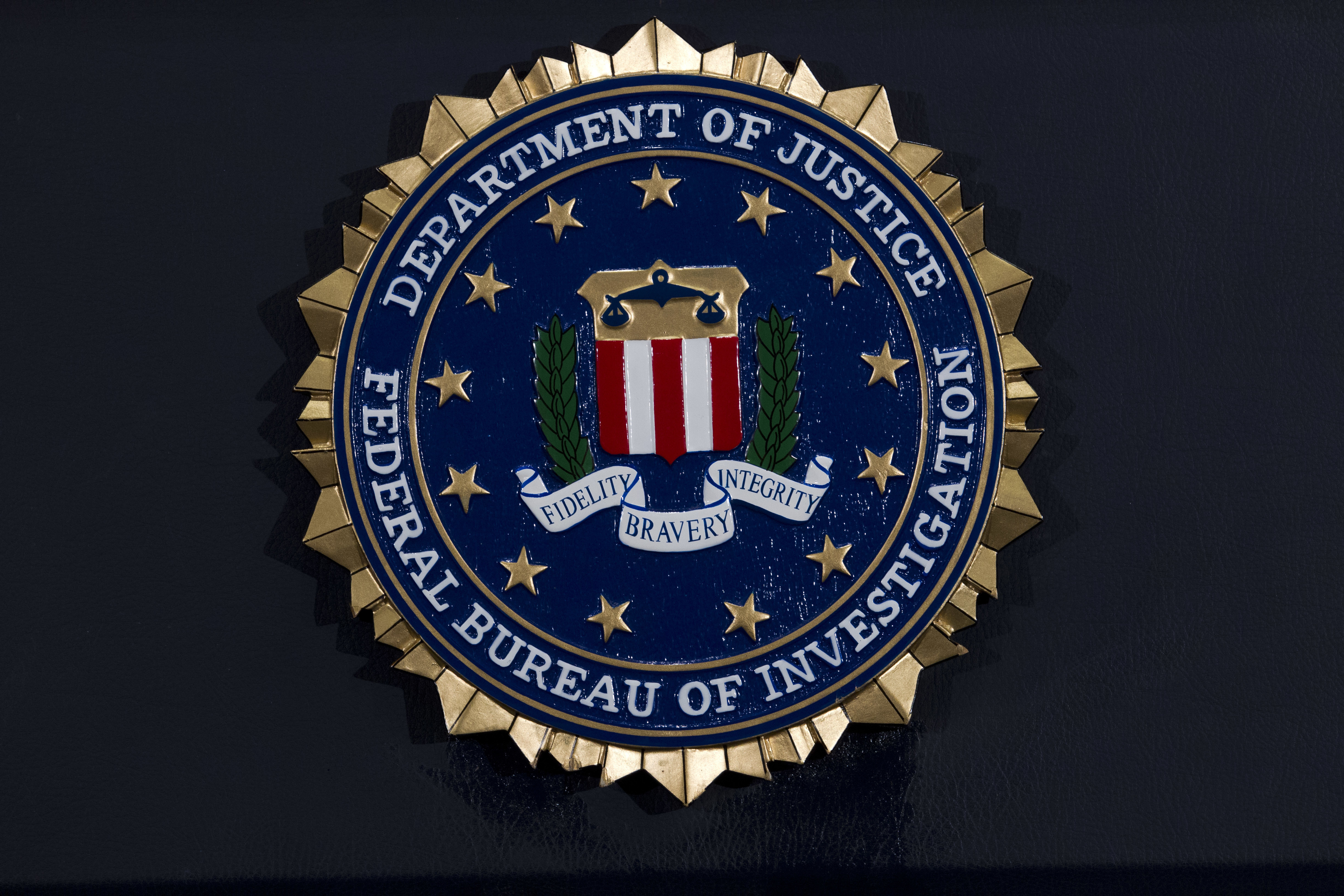 This Thursday, June 14, 2018, file photo, shows the FBI seal at a news conference at FBI headquarters in Washington.(AP Photo/Jose Luis Magana, File)